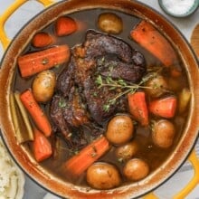 A pot roast recipe cooked in a Dutch oven with carrots and potatoes