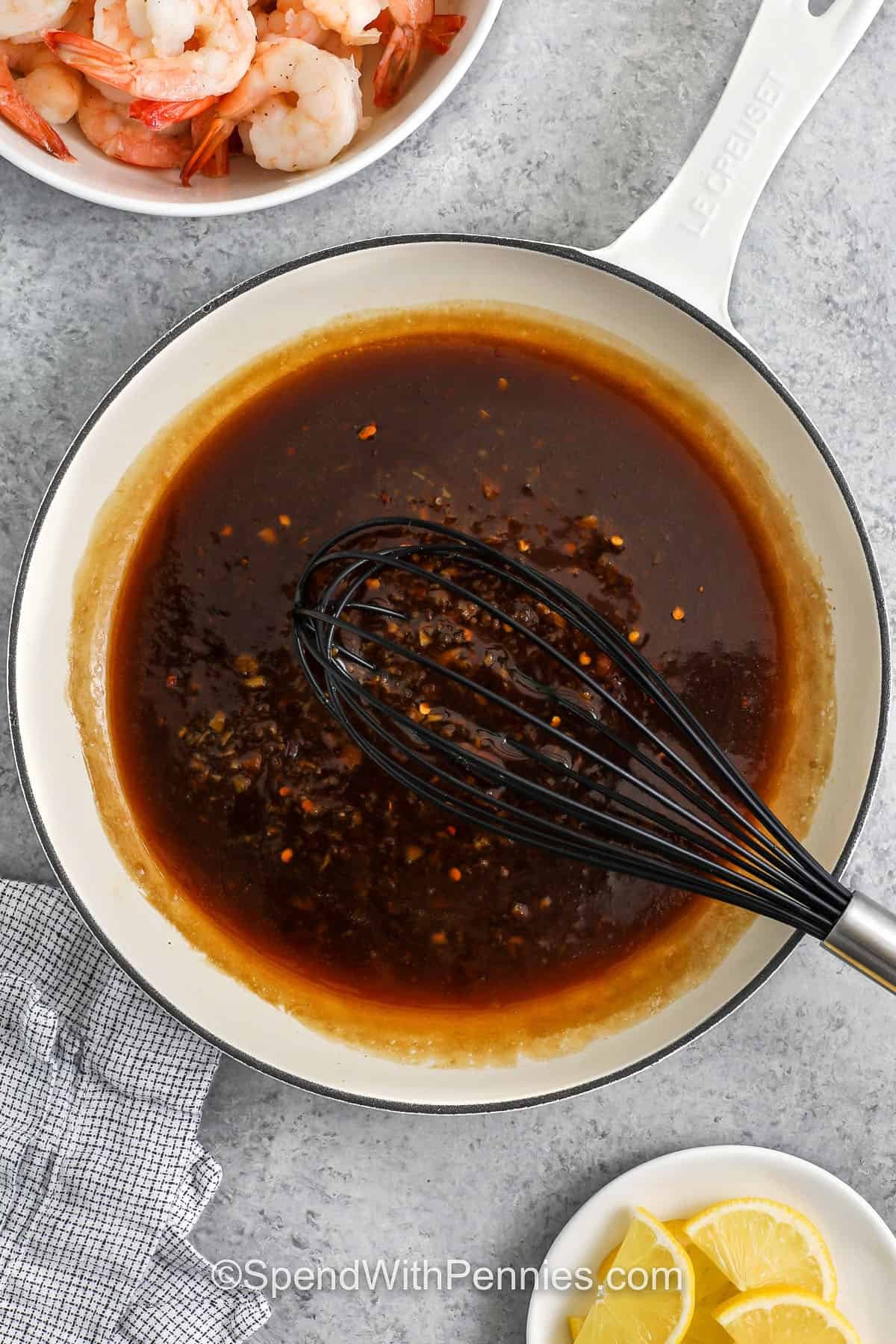 top view of sauce to make honey garlic shrimp with a whisk