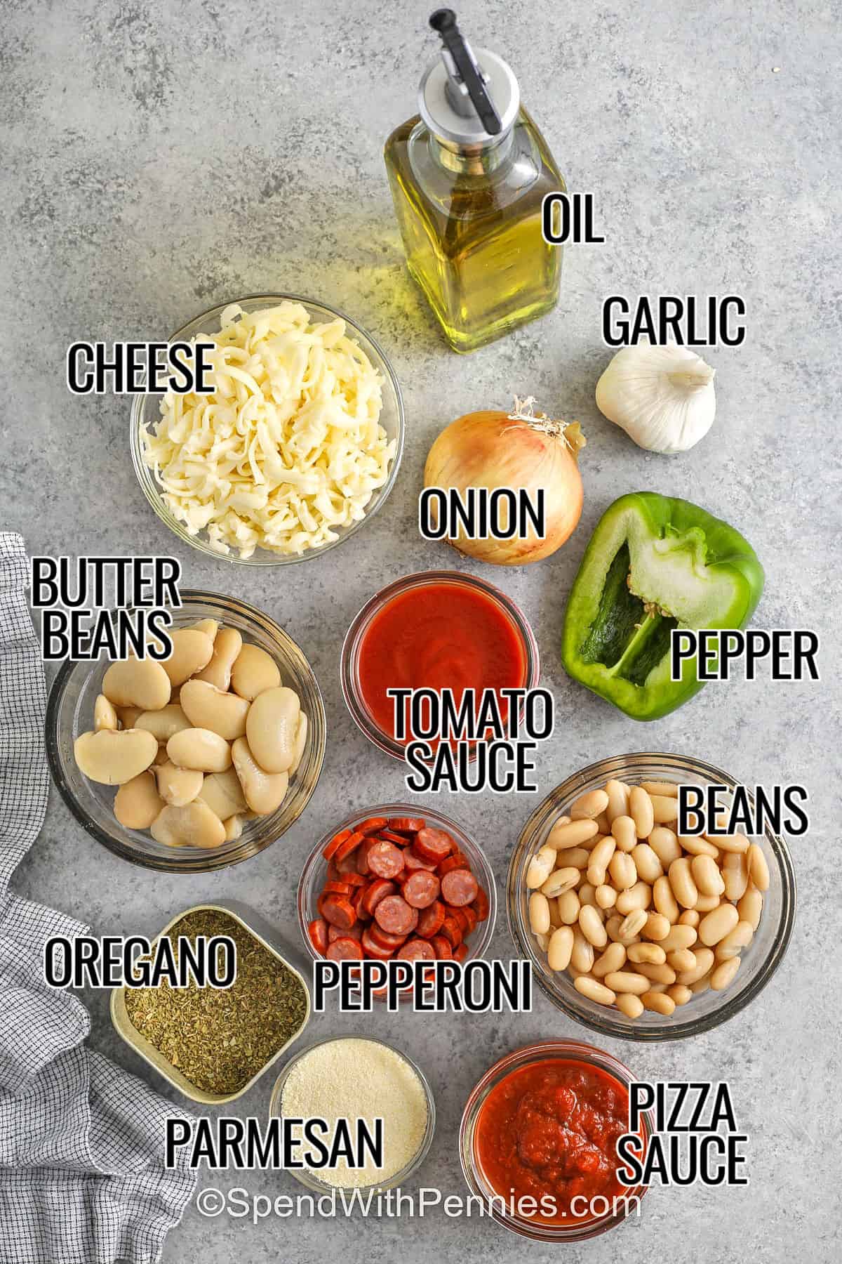 Pizza beans mix soft white beans, rich tomato sauce, smooth pizza sauce, and pepperoni for a simple baked dish that bubbles gently in the oven. The cheese melts nicely and gives a warm and stretchy top layer. Black olives or mushrooms can be added if you want a little more flavor. Serve with garlic bread so none of the sauce goes to waste. #spendwithpennies cheese , oil , garlic , onion , pepper , tomato sauce , butter beans , pepperoni , oregano , parmesan , pizza sauce , beans , cheese with labels to make Pizza Beans