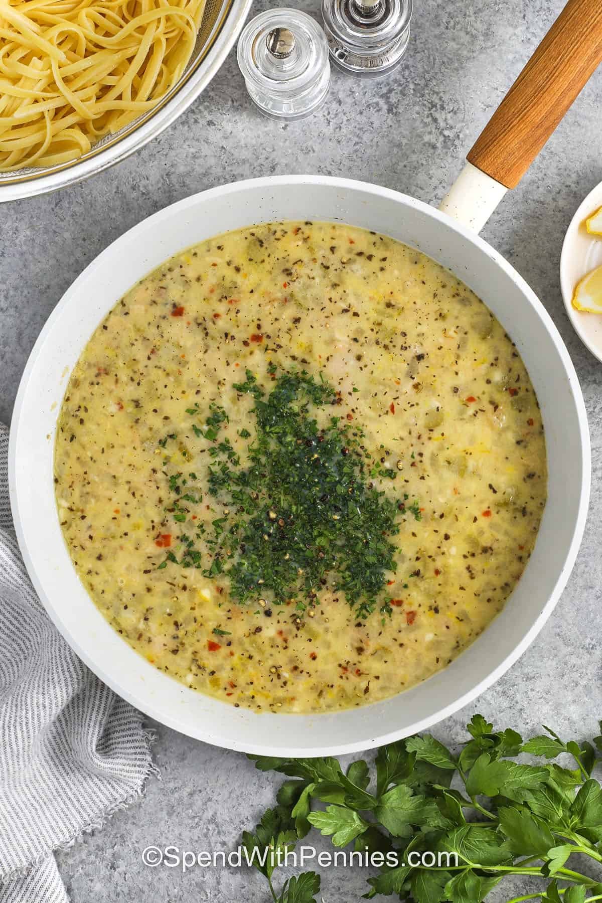 Linguine with clam sauce makes a fresh, restaurant-style pasta dinner at home using clams and simple ingredients. Garlic, celery, and onion mingle with white wine and butter for a sauce that coats every strand of linguine with savory flavor. A touch of lemon zest and fresh parsley brightens the dish, making it one of the best ways to enjoy seafood pasta. Serve this easy pasta recipe anytime you want a flavorful, fresh twist on a classic Italian favorite. #spendwithpennies adding seasonings to pan to make Linguine with Clam Sauce