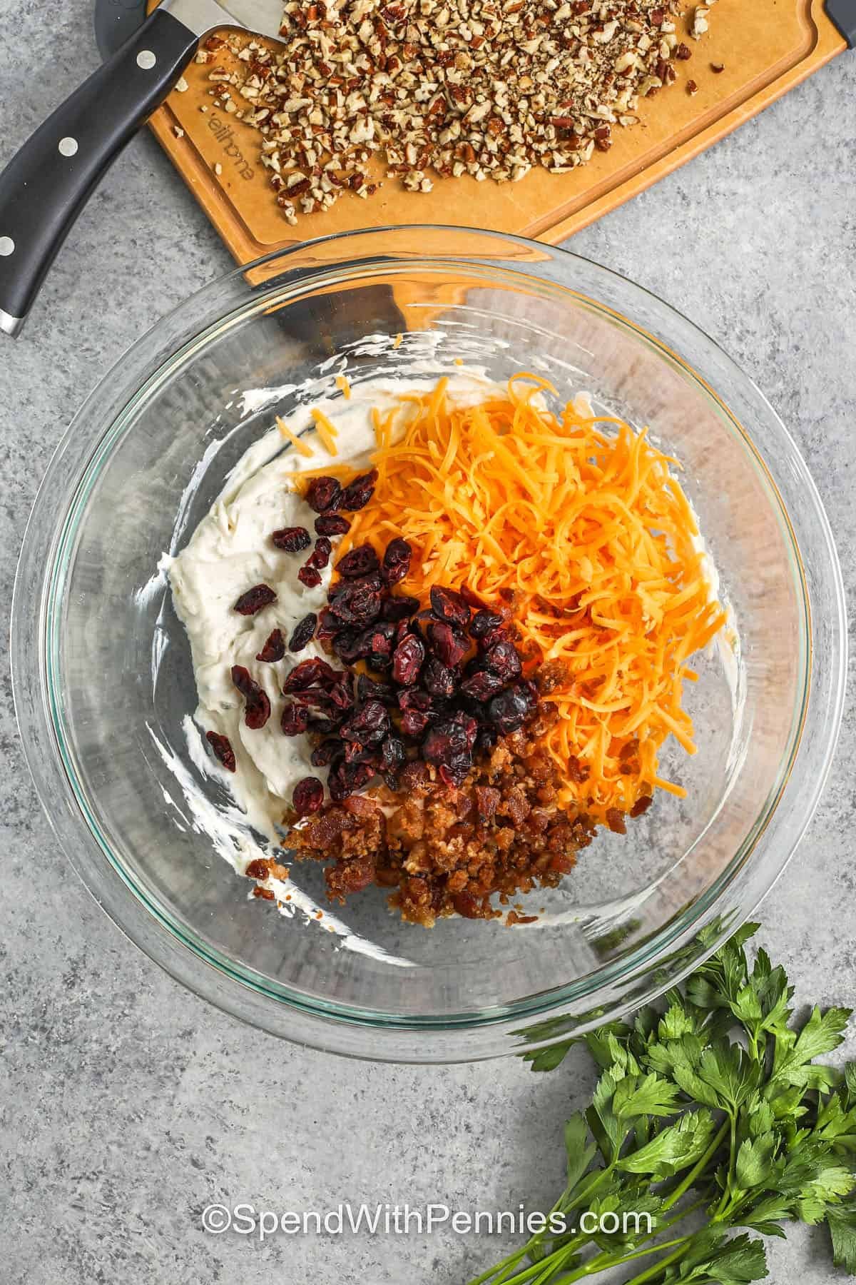 adding ingredients to bowl to make cheesy bacon and pecan coating for Mini Cheese Balls