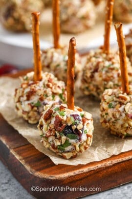 Mini Cheese Balls on a wooden cutting board with parchment paper