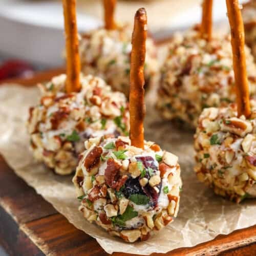 Mini Cheese Balls on a wooden cutting board with parchment paper