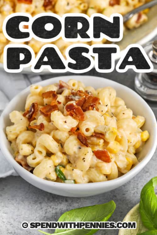 bowl of creamy corn pasta with bacon, with writing