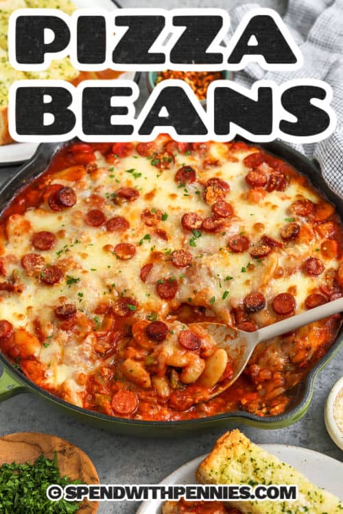 Pizza beans make a warm and cozy dish that feels playful and fun with tender white and butter beans baked in a rich mix of pizza sauce, tomato sauce, and little bites of pepperoni. The cheese melts into a soft layer on top, and the edges bubble gently. You can add Black olives or mushrooms for even more flavor. Serve it with bread to scoop up every bit of sauce. #spendwithpennies pan of cheesy Pizza Beans with a title