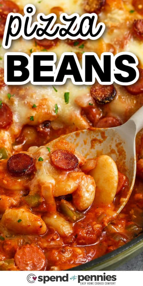 Pizza beans make a hearty family meal with white and butter beans folded into pizza sauce and tomato sauce, along with pepperoni for a boost of savory flavor. The cheese melts into a soft topping that makes every bite warm and creamy. Add black olives or chopped veggies if you want more color. It is great with slices of crusty bread for dipping. #spendwithpennies taking a spoonfull of Pizza Beans out of a pan with a title