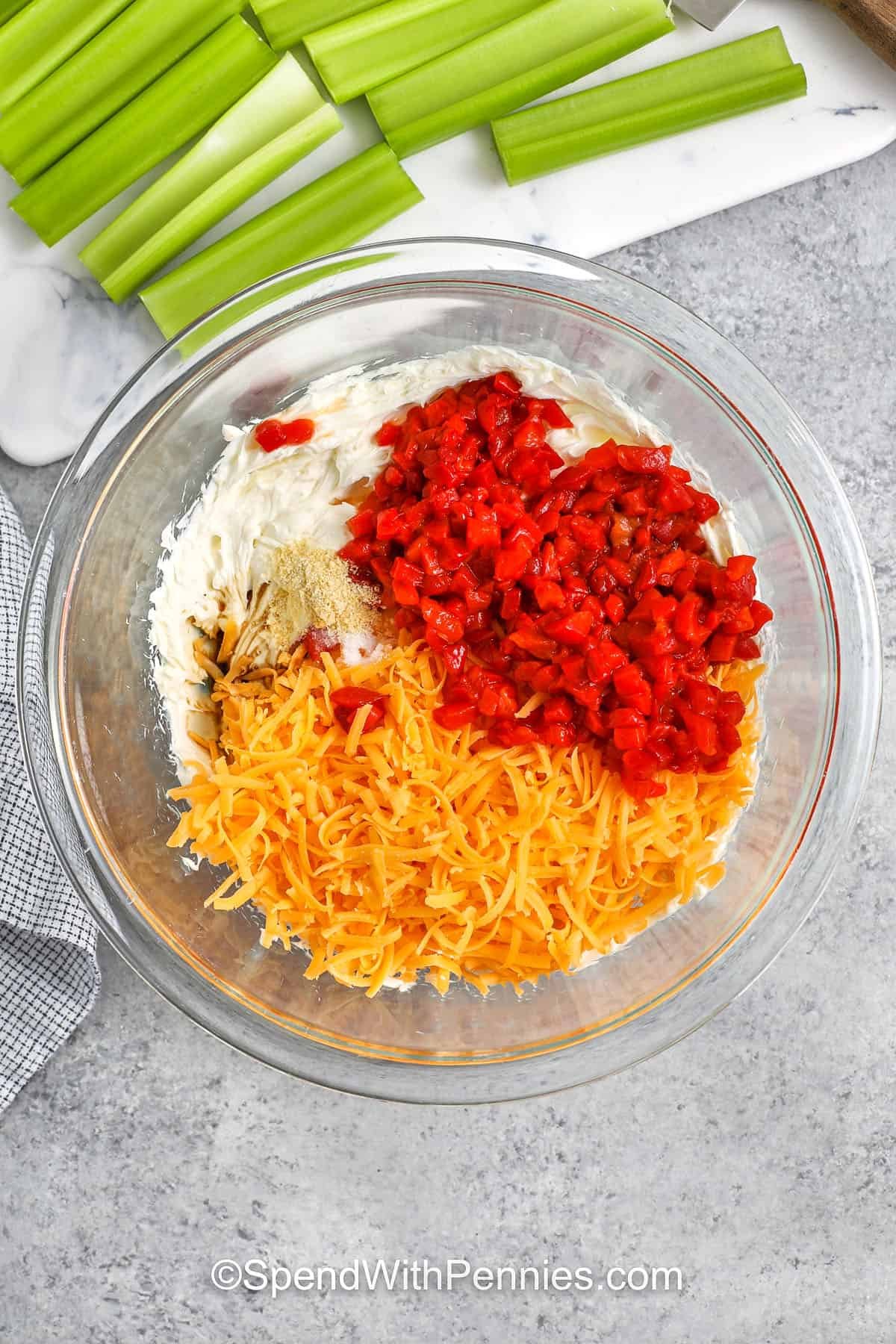 adding ingredients together to bowl to make Stuffed Celery