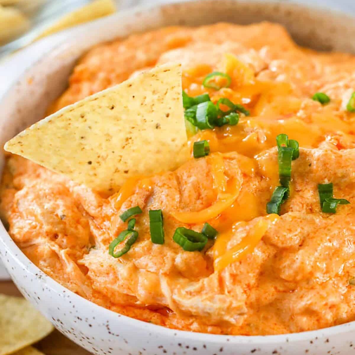 Crockpot Buffalo Chicken Dip in a bowl with a chip