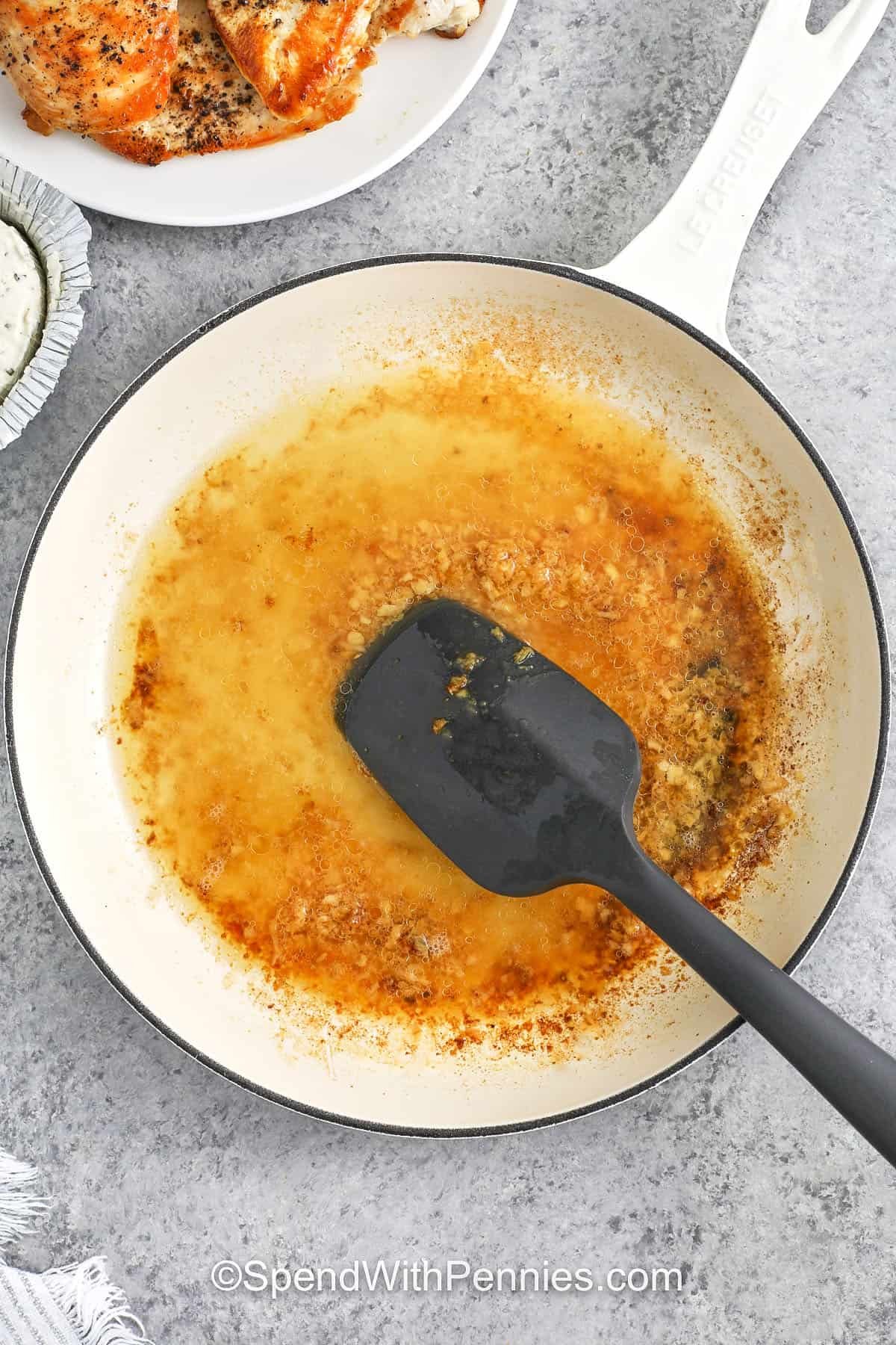 adding broth to garlic to make Boursin Chicken