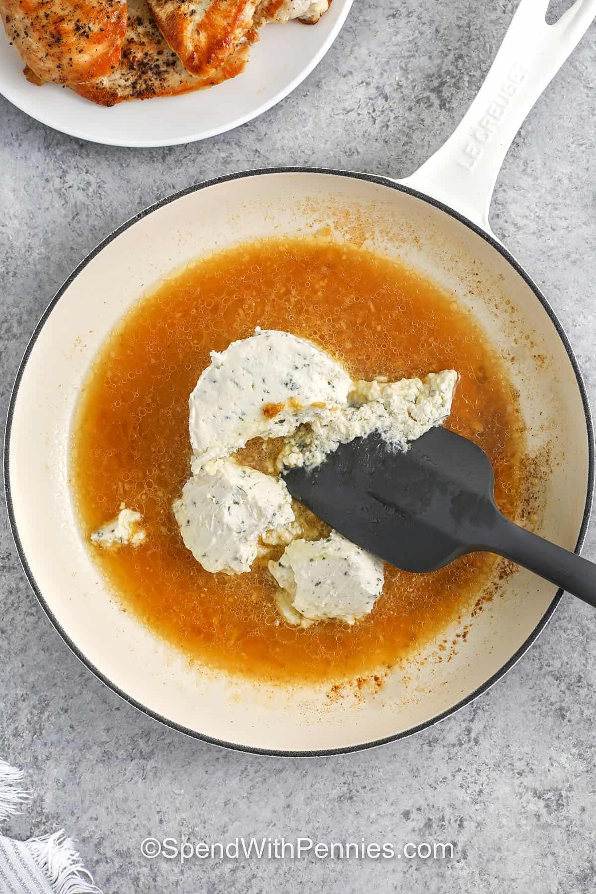 adding boursin cheese to pan to make Boursin Chicken