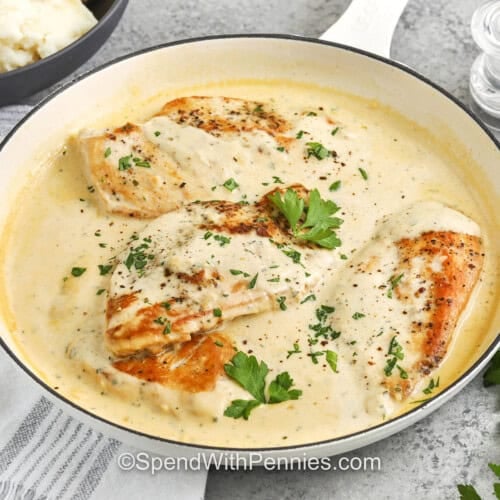 pan full of Boursin Chicken with a bowl of mashed potatoes