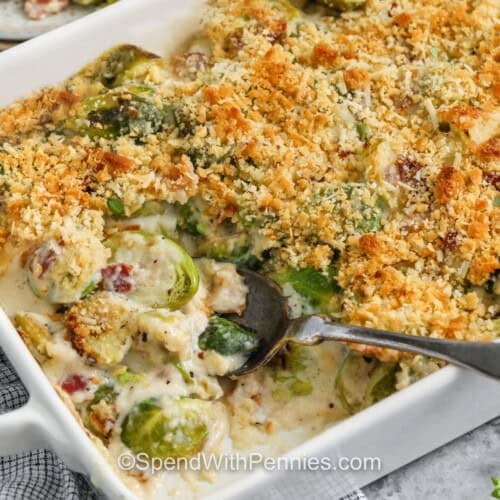 taking a spoonfull of Brussels Sprout Casserole out of the casserole dish