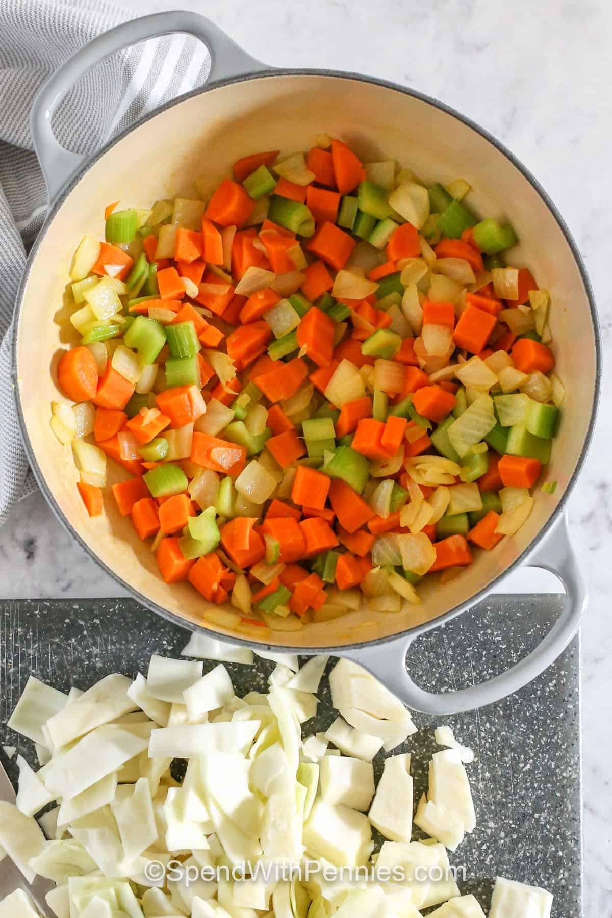 celery , carrots , onion cooked in a pot to make Cabbage Meatball Soup