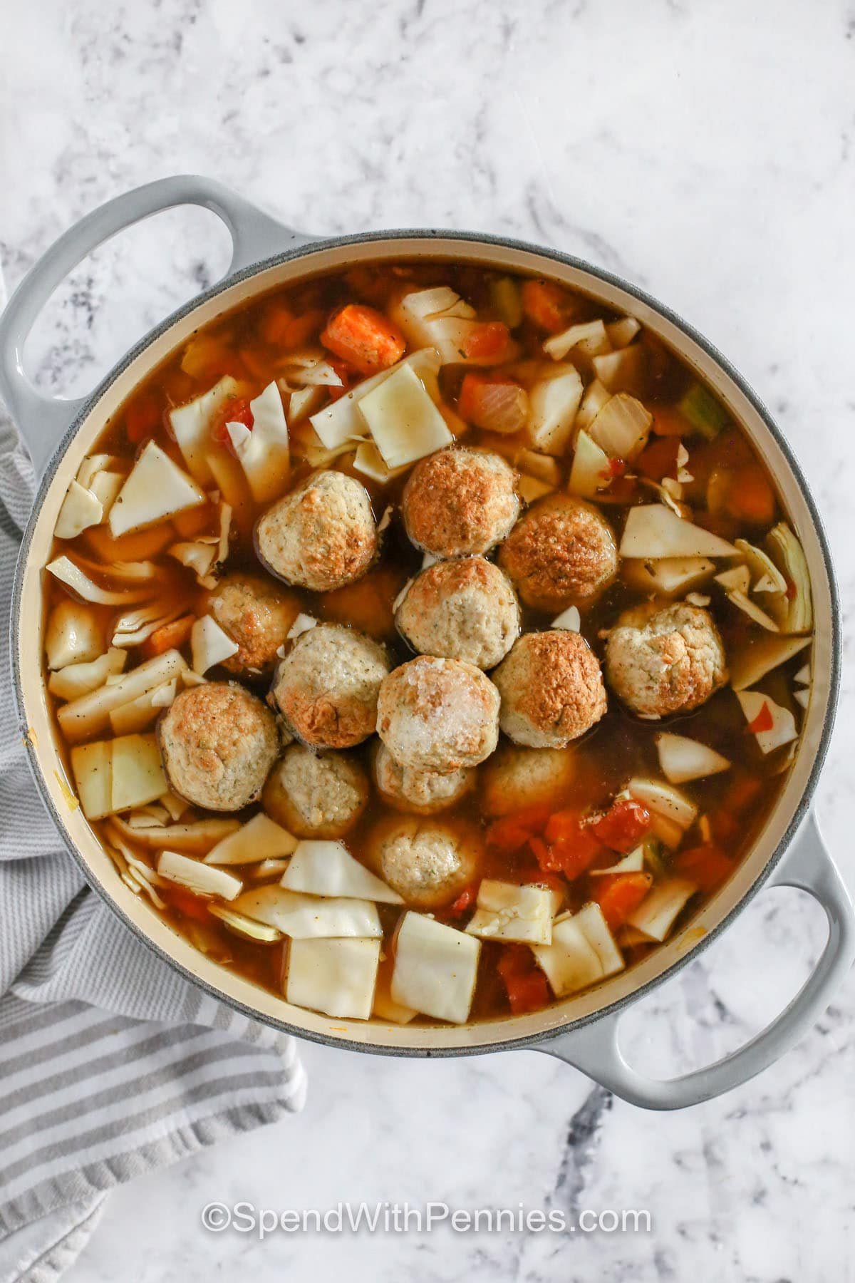 adding meatballs to soup to make Cabbage Meatball Soup