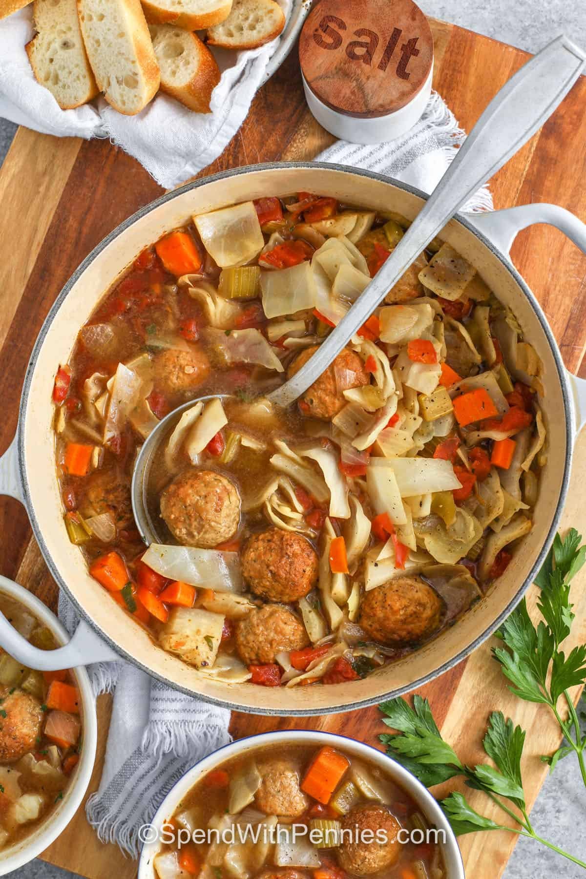top view of Cabbage Meatball Soup in a pot and bowls