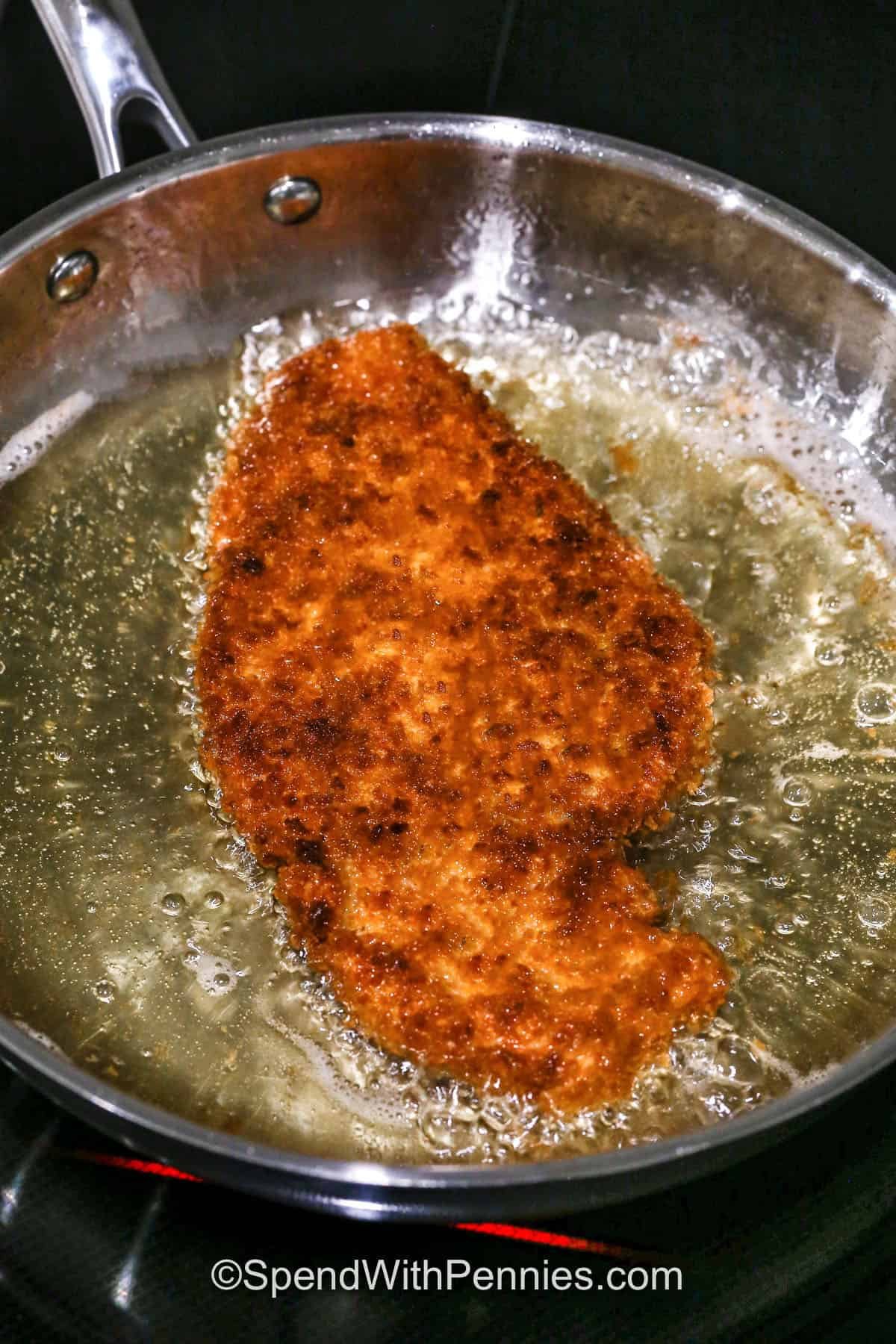 frying a piece of Chicken Katsu
