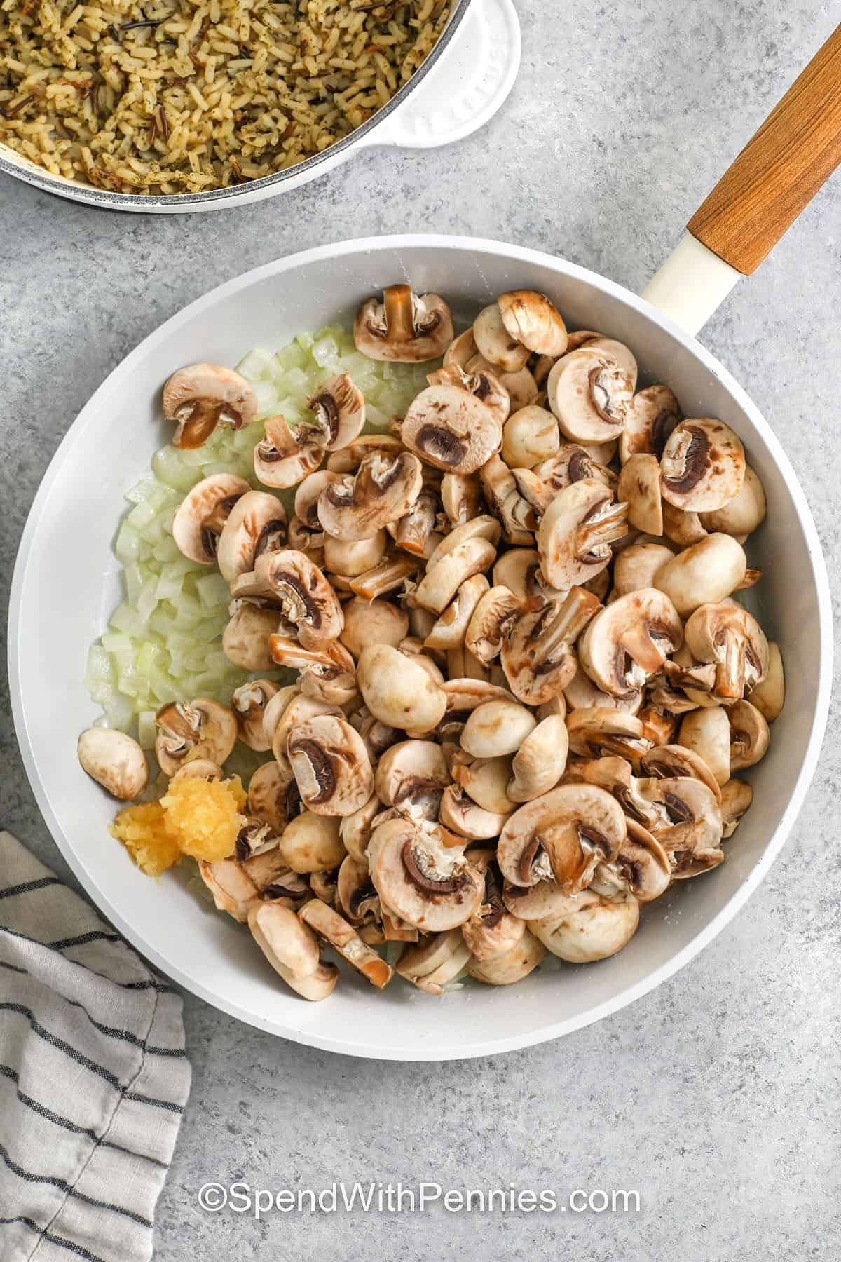 adding mushrooms and garlic to onions in pan to make Chicken Mushroom Casserole