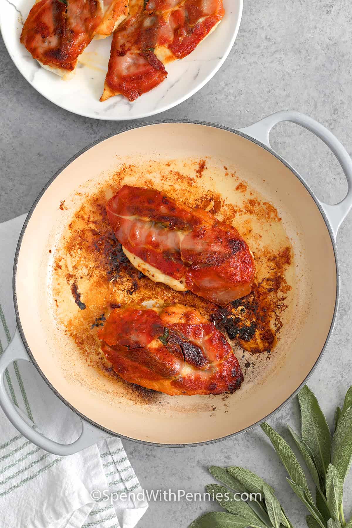 Chicken with sage leaves and prosciutto seared in a pan for chicken saltimbocca