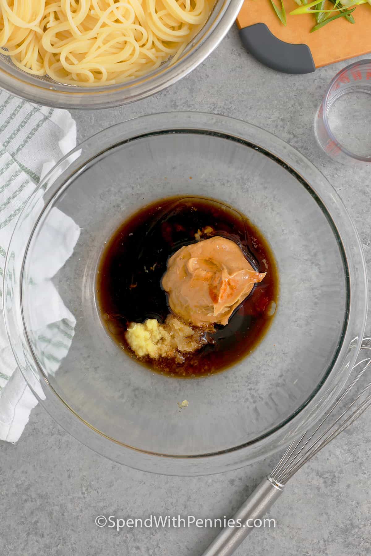 Peanut butter, soy sauce, rice vinegar, sesame oil, honey, sriracha, garlic, and ginger in a bowl to make the sauce for cold sesame noodles