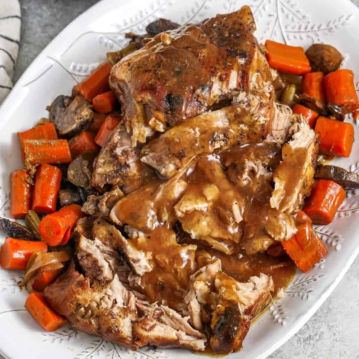 plate of Crock Pot Pork Roast with gravy and carrots