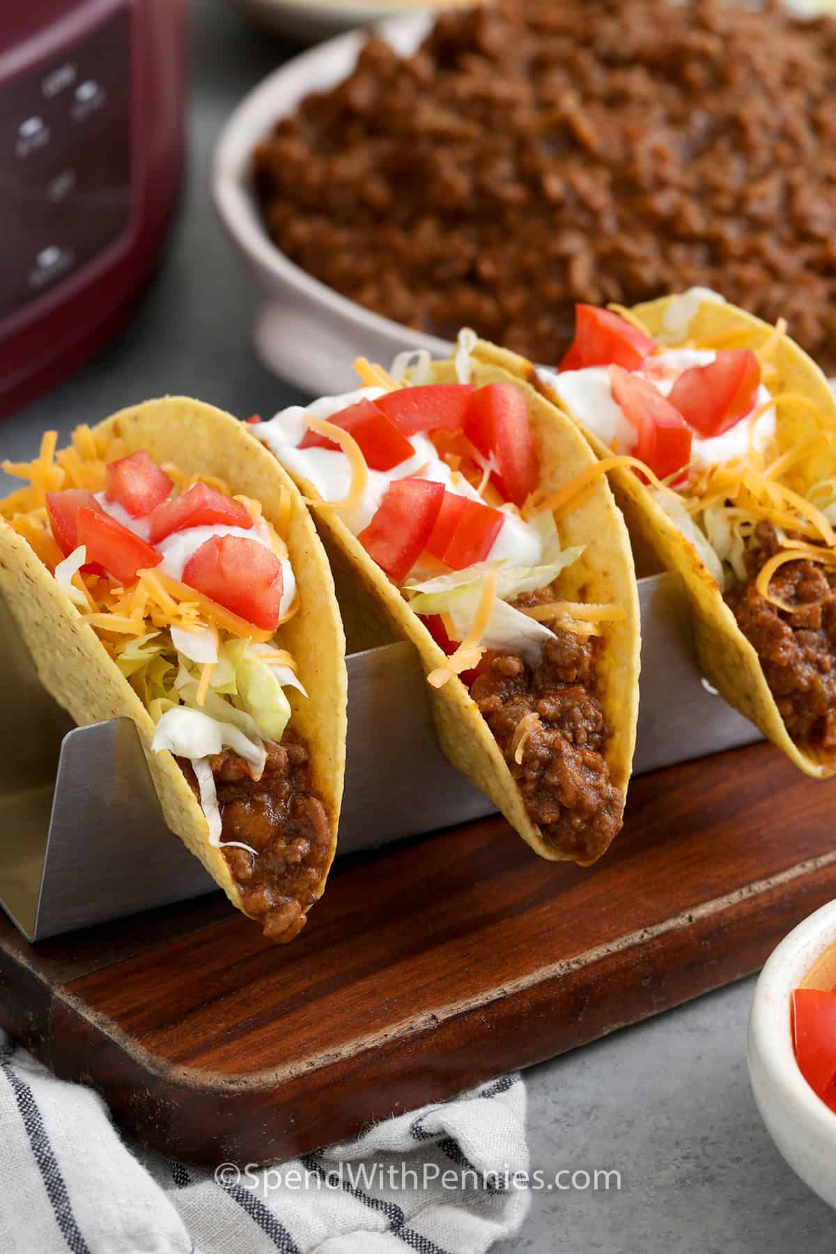 Three hard shell tacos topped with Crockpot Taco Meat and classic taco toppings.