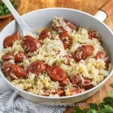 Kielbasa and Sauerkraut in a pan with a spoon