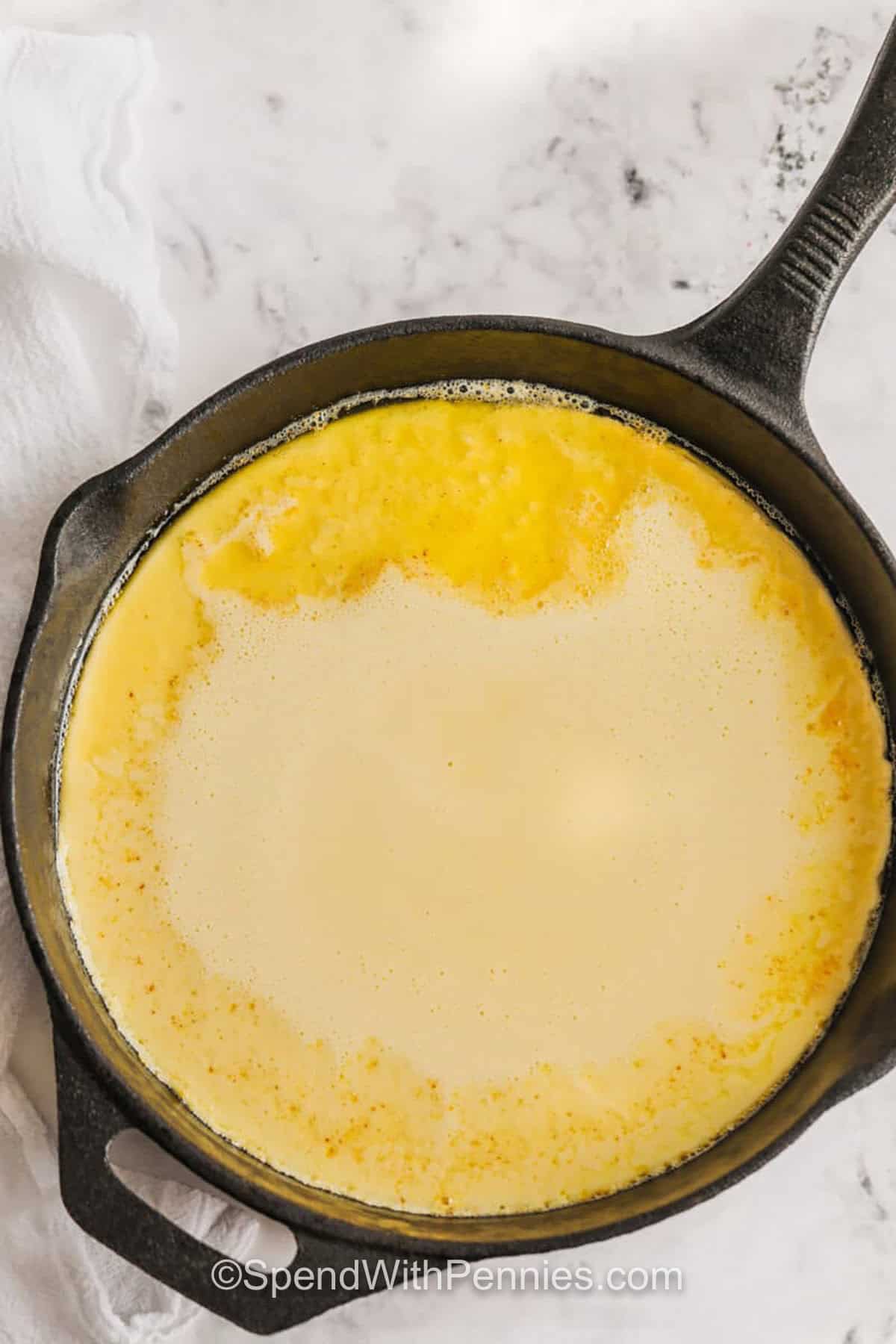 pan full of Dutch Baby Pancakes batter