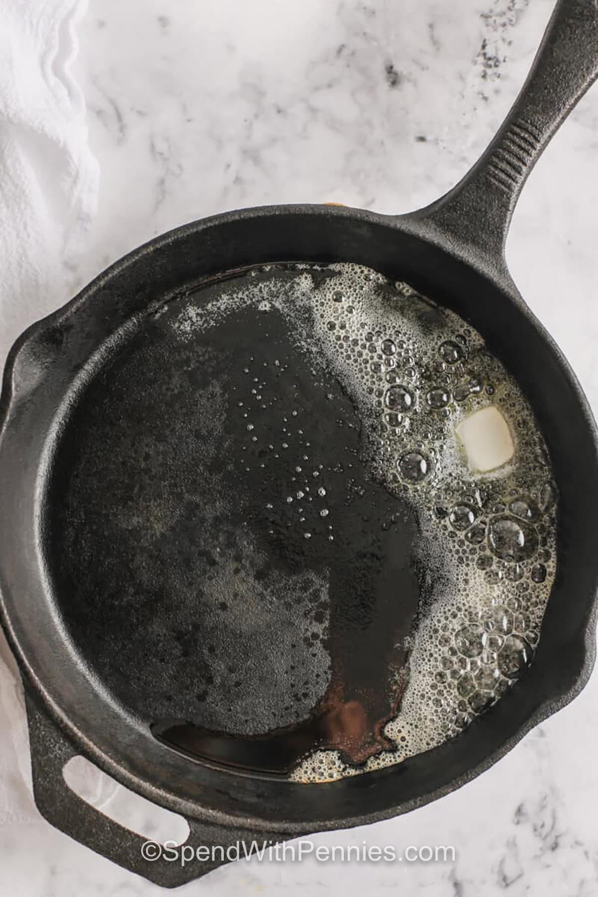 melted butter in pan to make Dutch Baby Pancakes