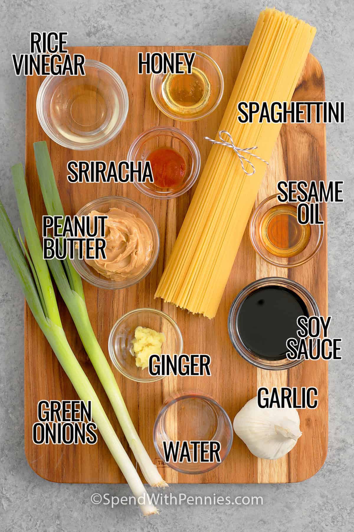 Rice vinegar, honey, spahettini, sriracha, sesame oil, peanut butter, soy sauce, ginger, green onions, water, and garlic with labels to make Cold Sesame Noodles