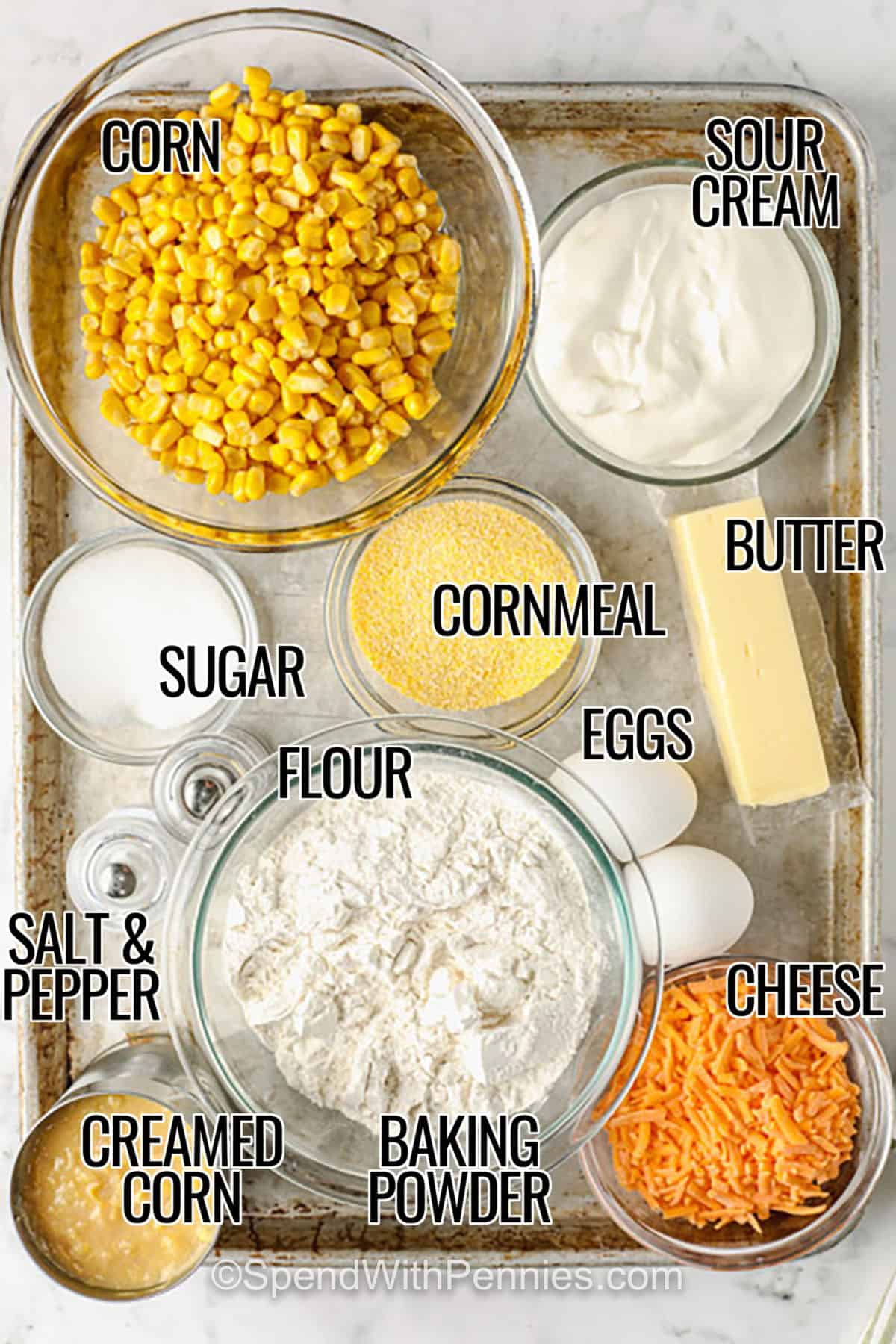 corn , sour cream , butter , cornmeal , eggs , sugar , flour, creamed corn , cheese , baking powder , salt and pepper with labels to make Cornbread Casserole