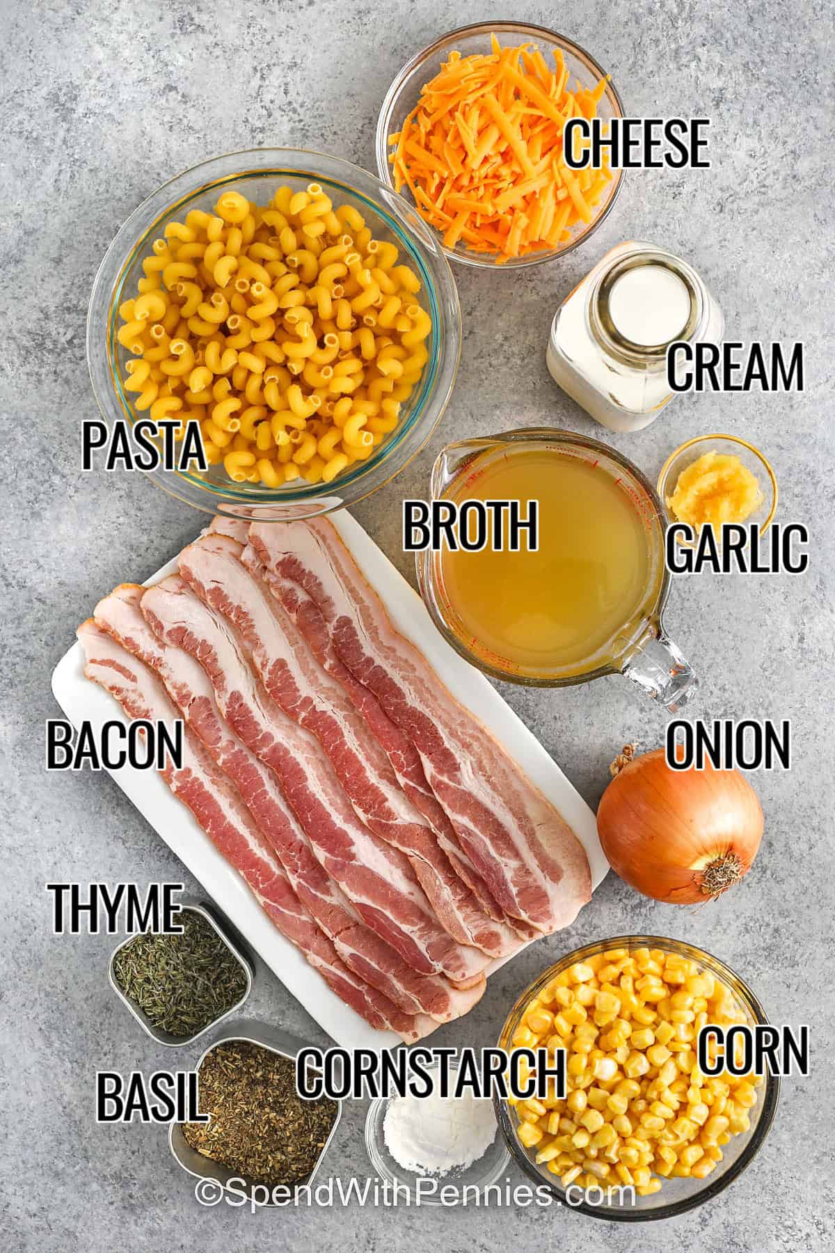Ingredients to make corn pasta including cheese, pasta, cream, broth, garlic, onion, bacon, thyme, basil, cornstarch, and corn