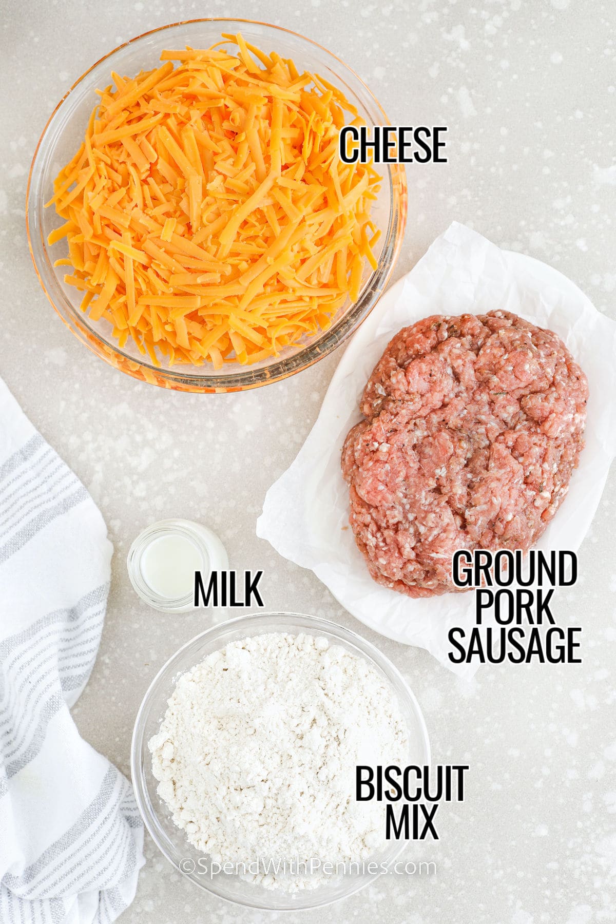 These sausage balls are made with Bisquick, sharp cheddar, and savory ground sausage for an easy appetizer that fits any gathering. The mixture comes together quickly and bakes into golden, tender bites with great flavor. They freeze well, reheat beautifully, and are perfect for parties, brunch spreads, or snacks. With just a few simple ingredients, this recipe delivers dependable, delicious results every time. #spendwithpennies cheese , ground pork sausage , milk and biscuit mix with labels to make Sausage Balls
