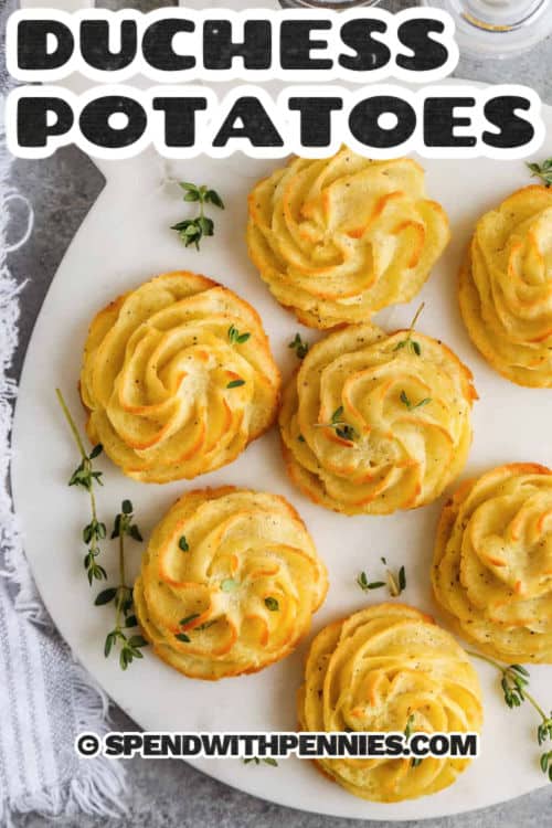 Make duchess potatoes for an impressive side featuring piped potatoes baked until crisp on the outside and soft inside. Russet potatoes give the best structure for piping, and butter and a touch of nutmeg add rich flavor. They can be made ahead and baked just before serving, which makes them ideal for gatherings and holiday dinners. #spendwithpennies crispy Duchess Potatoes on a plate with a title