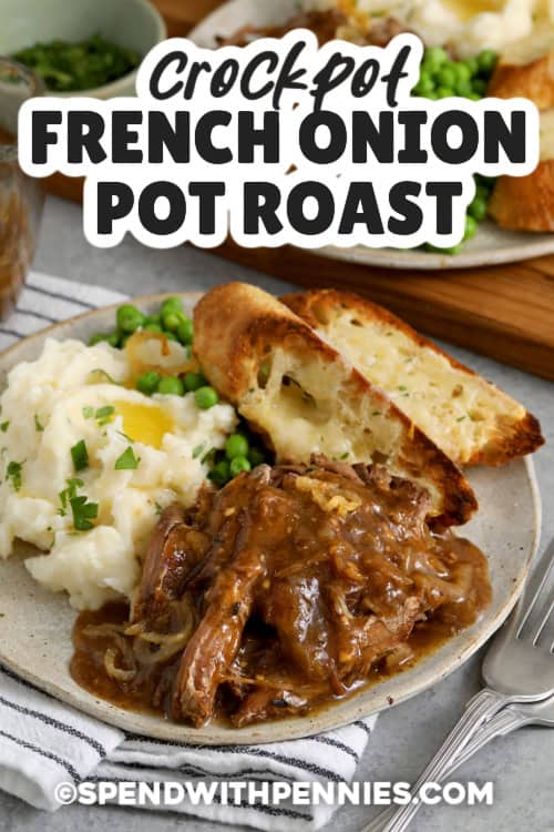 This slow cooker pot roast brings French onion flavor to a classic homemade dinner using chuck roast, sliced onions, garlic, thyme, and a splash of white wine. Searing the beef first adds rich flavor, and then the slow cooker does the rest. The onions cook down into the beef drippings, and a quick cornstarch slurry thickens everything into an easy onion gravy. It serves well over mashed potatoes, noodles, or rice. #spendwithpennies Dinner plates with Crockpot French Onion Pot Roast, mashed potatoes, peas, and cheese toasts with title.