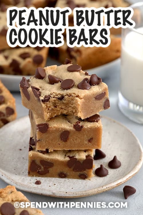 Stack of three Peanut Butter Cookie Bars on a plate with a bite out of the top one with a title.
