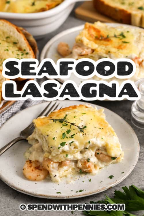seafood lasagna on a plate with a fork and writing