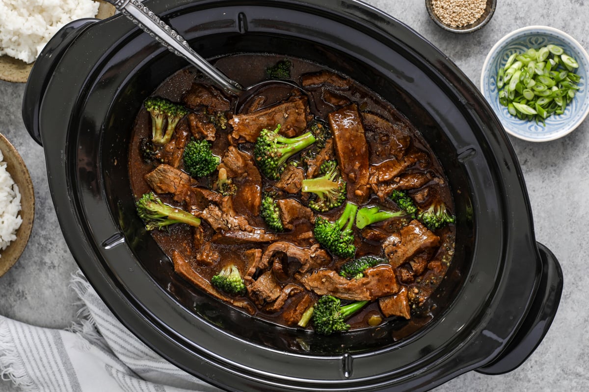 A slow cooker filled with beef and broccoli