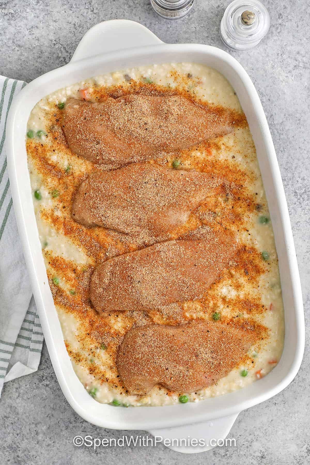 adding chicken to dish to make No Peek Chicken