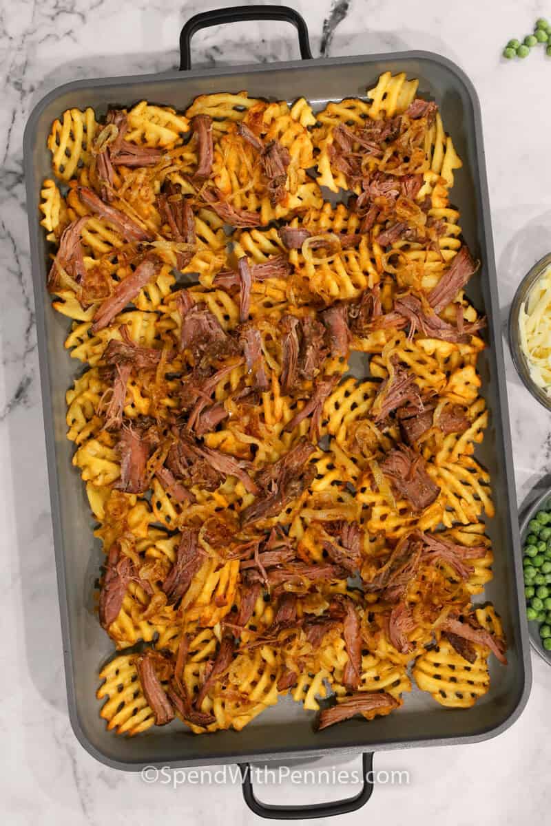 a tray of waffles fries with leftover pot roast