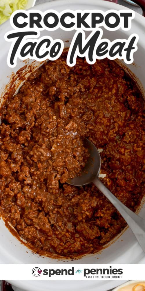Overhead of a crockpot with saucy Taco meat and a spoon with text