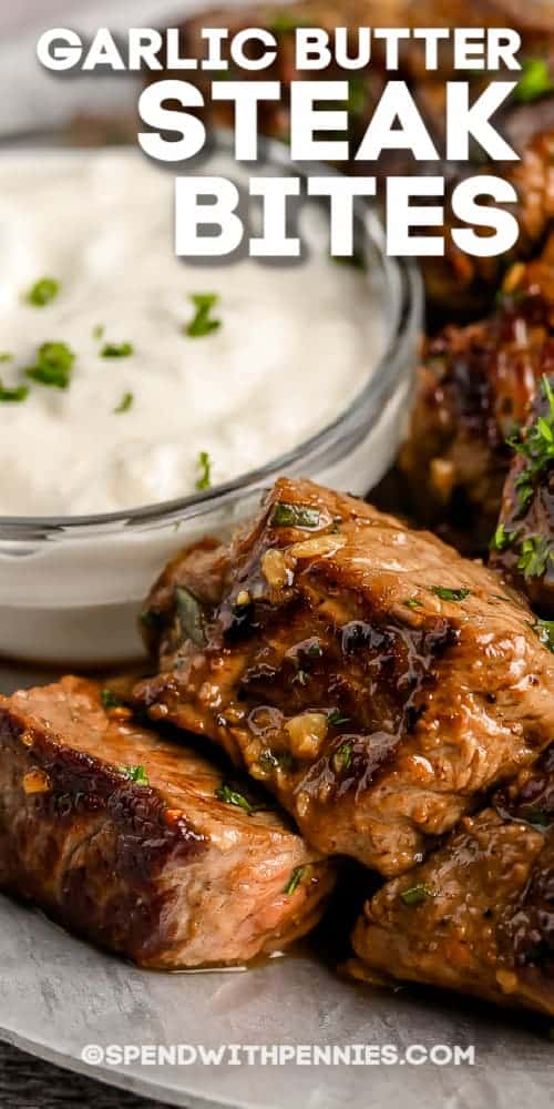 Close up of garlic butter steak bites on a plate with text