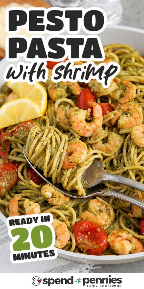 shrimp pesto pasta with a fork twirling the pasta, in a bowl with writing