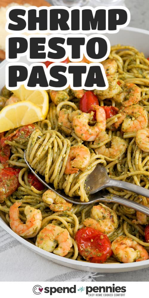 shrimp pesto pasta with a fork twirling the spaghetti, and writing