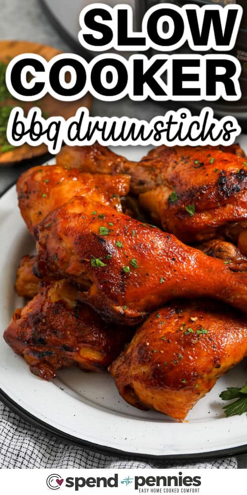 close up of honey bbq Slow Cooker Chicken Drumsticks on a plate with writing