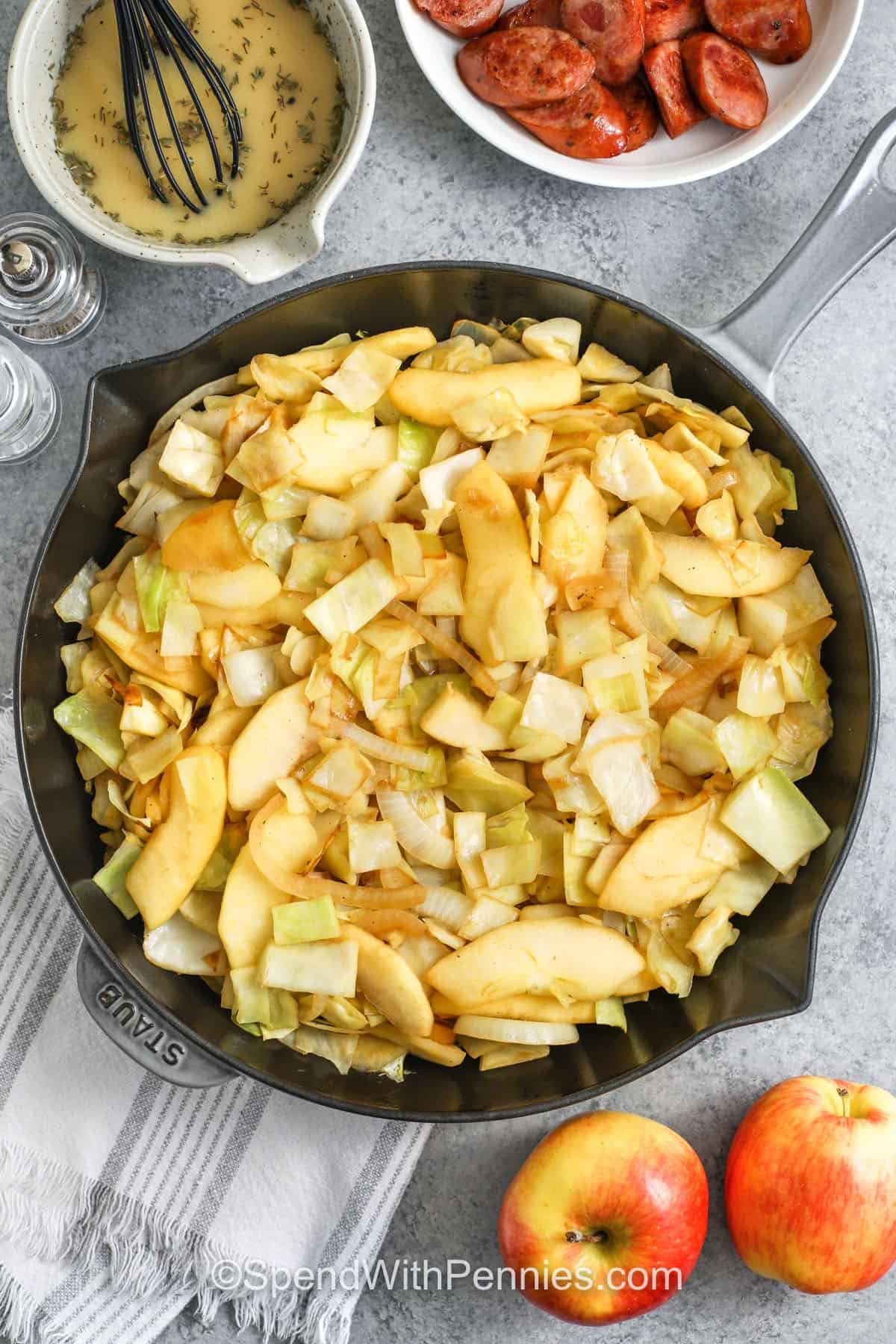 cooked Sausage, Cabbage, and Apple Skillet in a pan