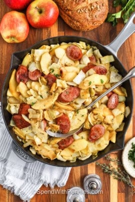 pan of Sausage, Cabbage, and Apple Skillet with a spoon
