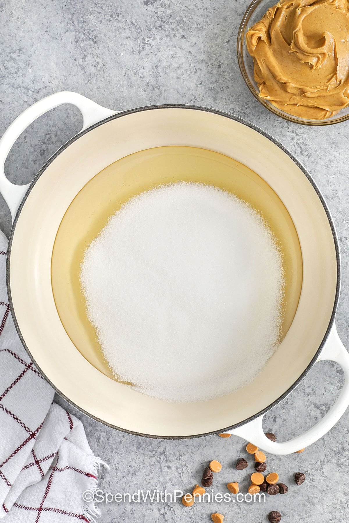 This Scotcheroos recipe brings together peanut butter, cereal, chocolate, and butterscotch in a simple no-bake bar. The syrup holds the cereal just right, giving each bite a chewy yet crisp texture. The topping melts smoothly in the microwave and spreads evenly for a polished finish. These bars are great for sharing and stack well in containers, making them a convenient and delicious dessert option. #spendwithpennies adding sugar to corn syrup to make Scotcheroos