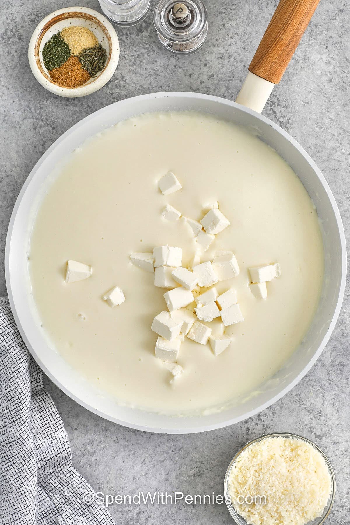 adding cream cheese to roux to make sauce for Seafood Lasagna