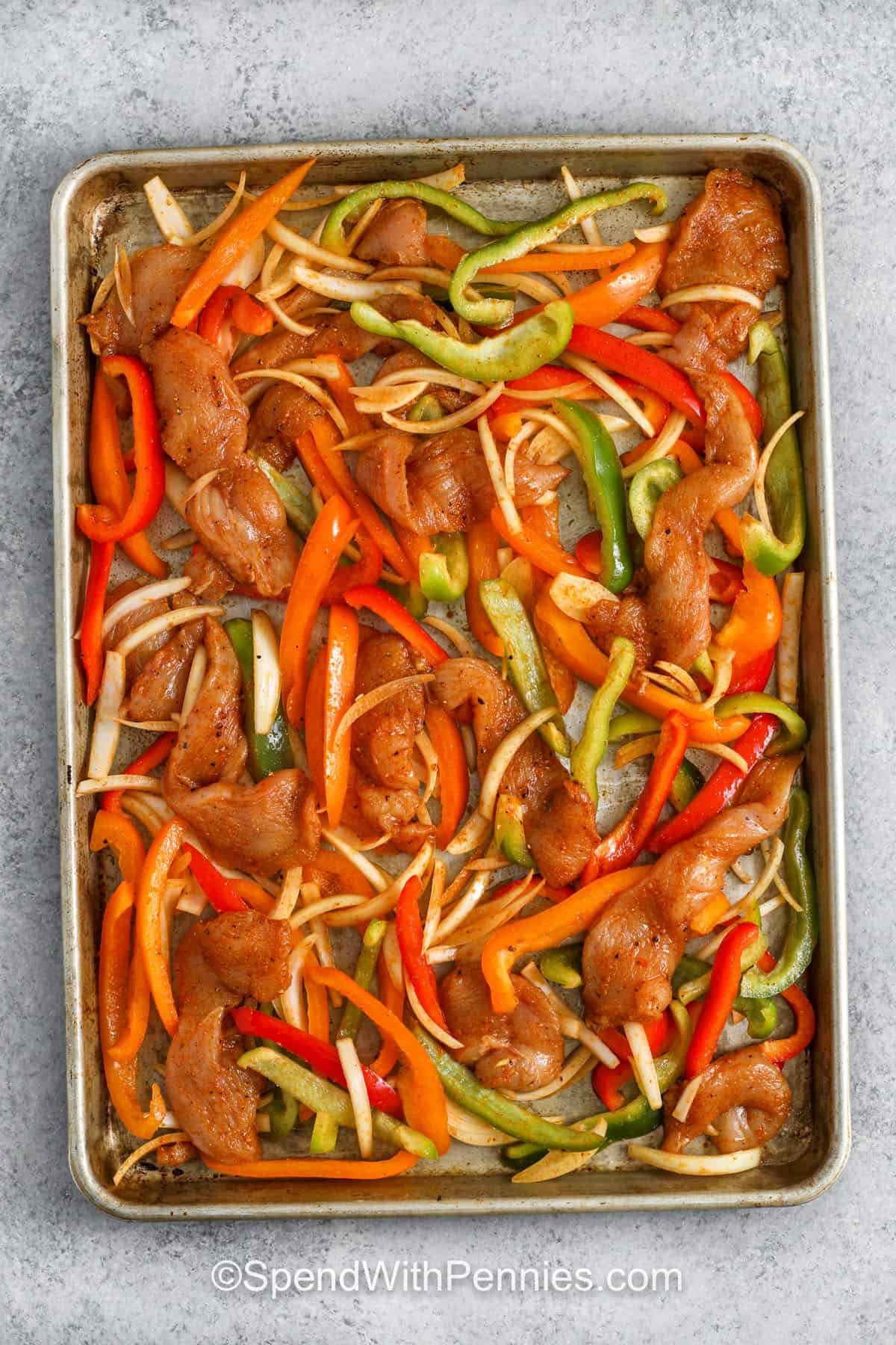 ingredients on sheet pan to make Sheet Pan Chicken Fajitas