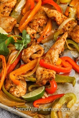 taking Sheet Pan Chicken Fajitas off the sheet pan